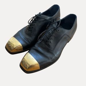 Alexander McQueen black leather men’s loafers with metal toe.